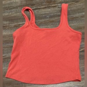 A red top not too croped but still short and good quality, it’s a reddish pink